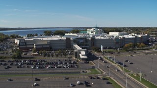 5.7K aerial stock footage descend and fly away from parking lots and the Destiny USA shopping mall, Syracuse, New York Aerial Stock Footage | DX0002_212_027