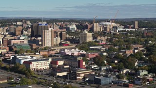 5.7K aerial stock footage of Carrier Dome stadium behind office buildings in Downtown Syracuse, New York Aerial Stock Footage | DX0002_213_012