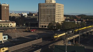 5.7K aerial stock footage of a train near the 500 Building, Downtown Syracuse, New York Aerial Stock Footage | DX0002_214_002