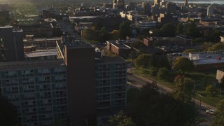 DX0002_214_009 - 5.7K aerial stock footage of orbiting Dellplain Hall at Syracuse University at sunset, New York