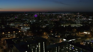 5.7K aerial stock footage city buildings lit up for the evening in Downtown Syracuse at twilight, New York Aerial Stock Footage | DX0002_215_004