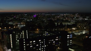 5.7K aerial stock footage of city buildings in Downtown Syracuse at twilight while ascending over university, New York Aerial Stock Footage | DX0002_215_007