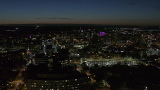 5.7K aerial stock footage flying by Syracuse University at twilight while focused on Downtown Syracuse, New York Aerial Stock Footage | DX0002_215_017