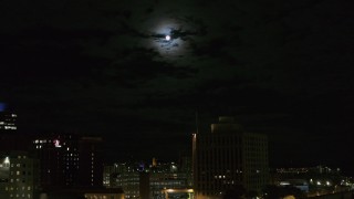 5.7K aerial stock footage of the moon above the 500 Building at night, reveal apartment building, Downtown Syracuse, New York Aerial Stock Footage | DX0002_215_042