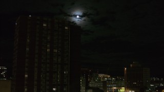 5.7K aerial stock footage of the moon while flying by apartment building, Downtown Syracuse, New York Aerial Stock Footage | DX0002_215_043