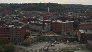 DX0002_216_014 - 5.7K aerial stock footage flying away from music hall and brick buildings the downtown area of Troy, New York