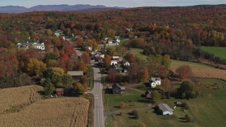 DX0002_217_009 - 5.7K aerial stock footage of orbiting Main Street in a small town beside a forest in autumn, Orwell, Vermont