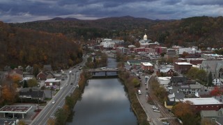 5.7K aerial stock footage reverse view of a bridge spanning the Winooski River at sunset, Montpelier, Vermont Aerial Stock Footage | DX0002_220_002