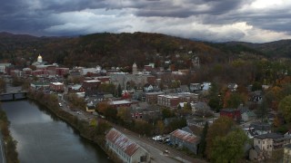 5.7K aerial stock footage of a wide orbit of city hall and brick buildings at sunset, approach from river, Montpelier, Vermont Aerial Stock Footage | DX0002_220_011