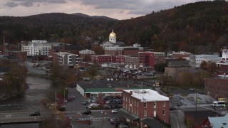 5.7K aerial stock footage the capitol dome at sunset seen from a bridge over the river, Montpelier, Vermont Aerial Stock Footage | DX0002_220_024