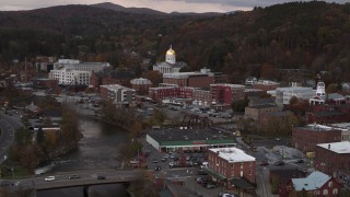 5.7K aerial stock footage ascend and fly away from capitol dome at sunset seen from the river, Montpelier, Vermont Aerial Stock Footage | DX0002_220_025