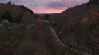 5.7K aerial stock footage of a road between hills with colorful trees at sunset, Montpelier, Vermont Aerial Stock Footage | DX0002_220_042