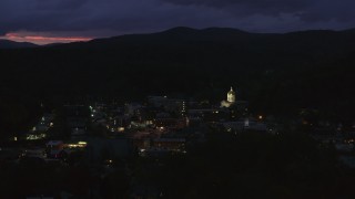 5.7K aerial stock footage of passing by city buildings around the capitol dome lit up at twilight, Montpelier, Vermont Aerial Stock Footage | DX0002_220_063