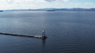 DX0002_222_010 - 5.7K aerial stock footage descend and orbit a lighthouse on Lake Champlain, Burlington, Vermont