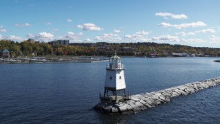 DX0002_222_022 - 5.7K aerial stock footage approach and ascend over a lighthouse on Lake Champlain toward downtown, Burlington, Vermont