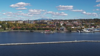 5.7K aerial stock footage a view of downtown buildings seen while descending by breakwaters, Burlington, Vermont Aerial Stock Footage | DX0002_224_014