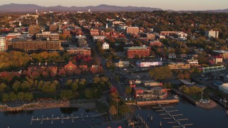 DX0002_225_010 - 5.7K aerial stock footage orbit buildings in downtown at sunset, Burlington, Vermont