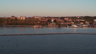 5.7K aerial stock footage fly over Lake Champlain breakwater at sunset to approach downtown, Burlington, Vermont Aerial Stock Footage | DX0002_225_018