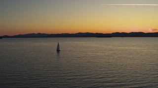 5.7K aerial stock footage of flying away from a sailboat on Lake Champlain at twilight, Burlington, Vermont Aerial Stock Footage | DX0002_225_036