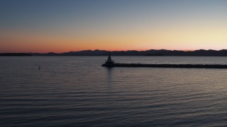 5.7K aerial stock footage of flying low to approach and fly over lighthouse on Lake Champlain at twilight, Burlington, Vermont Aerial Stock Footage | DX0002_226_002