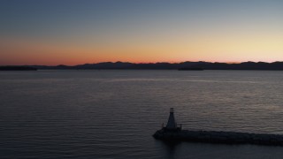 5.7K aerial stock footage reverse view of Lake Champlain at twilight, reveal a lighthouse, Burlington, Vermont Aerial Stock Footage | DX0002_226_003