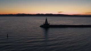 DX0002_226_006 - 5.7K aerial stock footage of orbiting around a Lake Champlain lighthouse at twilight, Burlington, Vermont