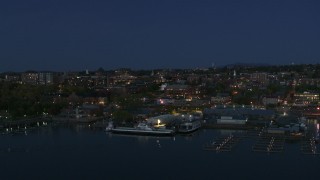 5.7K aerial stock footage fly away from the city's downtown area and a marina at night, Burlington, Vermont Aerial Stock Footage | DX0002_226_021