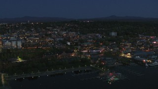 5.7K aerial stock footage focus on the city's downtown area lit up for the night while flying away, Burlington, Vermont Aerial Stock Footage | DX0002_226_025