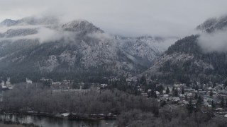 5.7K aerial stock footage a reverse view of Leavenworth and snowy mountains, Washington Aerial Stock Footage | DX0002_227_018