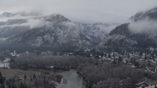 5.7K aerial stock footage of flying away from Leavenworth and snowy mountains, Washington Aerial Stock Footage | DX0002_227_019