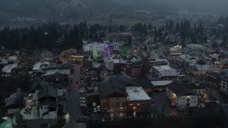 DX0002_227_045 - 5.7K aerial stock footage circling a small town while focused on Christmas trees and lights, Leavenworth, Washington