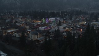 5.7K aerial stock footage fly away from a small town decorated with Christmas trees and lights, Leavenworth, Washington Aerial Stock Footage | DX0002_227_049