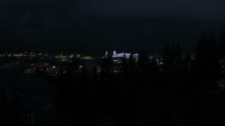 DX0002_228_019 - 5.7K aerial stock footage ascend to reveal and approach Christmas trees and lights at night in Leavenworth, Washington