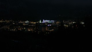 5.7K aerial stock footage orbit trees and buildings with Christmas lights at night, and descend, Leavenworth, Washington Aerial Stock Footage | DX0002_228_028