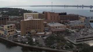 DX0003_229_017 - 5.7K aerial stock footage of orbiting a waterfront hospital in Tampa, Florida