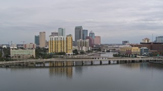 DX0003_229_037 - 5.7K aerial stock footage the city skyline behind a condo complex and channel, Downtown Tampa, Florida