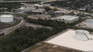 5.7K aerial stock footage of warehouse buildings and storage tanks in Tampa, Florida Aerial Stock Footage | DX0003_230_034