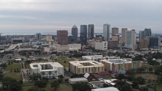 5.7K aerial stock footage orbit apartment buildings, reveal skyscrapers in the city's skyline, Downtown Tampa, Florida Aerial Stock Footage | DX0003_231_008