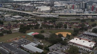 5.7K aerial stock footage of apartment buildings by elementary school, Tampa, Florida Aerial Stock Footage | DX0003_231_013