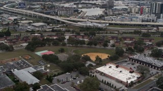 5.7K aerial stock footage orbit and fly away from apartment buildings by elementary school, Tampa, Florida Aerial Stock Footage | DX0003_231_014