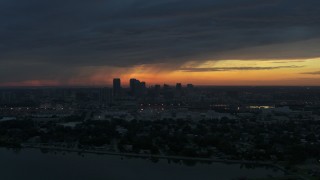 5.7K aerial stock footage a reverse view of the Downtown Tampa skyline from the bay at sunset, Florida Aerial Stock Footage | DX0003_231_049