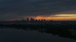 5.7K aerial stock footage a view of the Downtown Tampa skyline while flying over the bay at sunset, Florida Aerial Stock Footage | DX0003_231_051