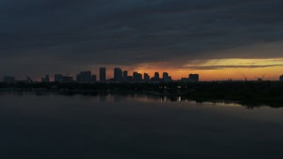 5.7K aerial stock footage a view of the Downtown Tampa skyline while flying low over the bay at sunset, Florida Aerial Stock Footage | DX0003_231_052