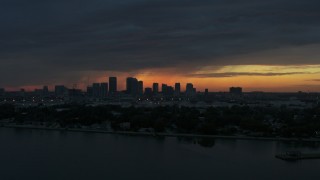 5.7K aerial stock footage ascending toward Downtown Tampa skyline from the bay at sunset, Florida Aerial Stock Footage | DX0003_231_054