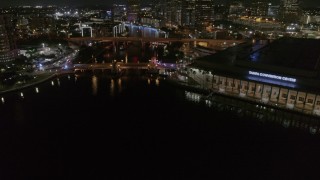 DX0003_232_049 - 5.7K aerial stock footage orbit police cars on the bridge by convention center at night in Downtown Tampa, Florida