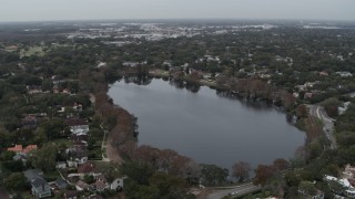 5.7K aerial stock footage ascend away from waterfront homes around Lake Adair, Orlando, Florida Aerial Stock Footage | DX0003_233_013