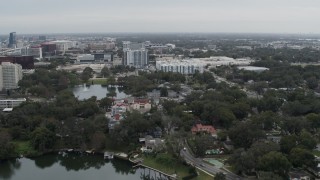 5.7K aerial stock footage of flying away from Lake Dot and apartment buildings in Orlando, Florida Aerial Stock Footage | DX0003_233_019