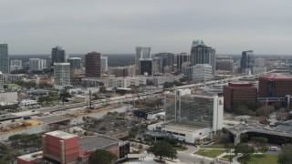 5.7K aerial stock footage a reverse view of the city's skyline from a nearby hotel, Downtown Orlando, Florida Aerial Stock Footage | DX0003_233_033