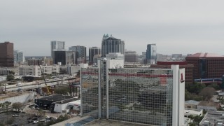 5.7K aerial stock footage ascend by hotel for view of office and apartment buildings, Downtown Orlando, Florida Aerial Stock Footage | DX0003_233_042