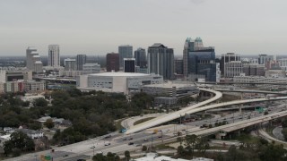 5.7K aerial stock footage of flying by Amway Center and city skyline, Downtown Orlando, Florida Aerial Stock Footage | DX0003_234_016